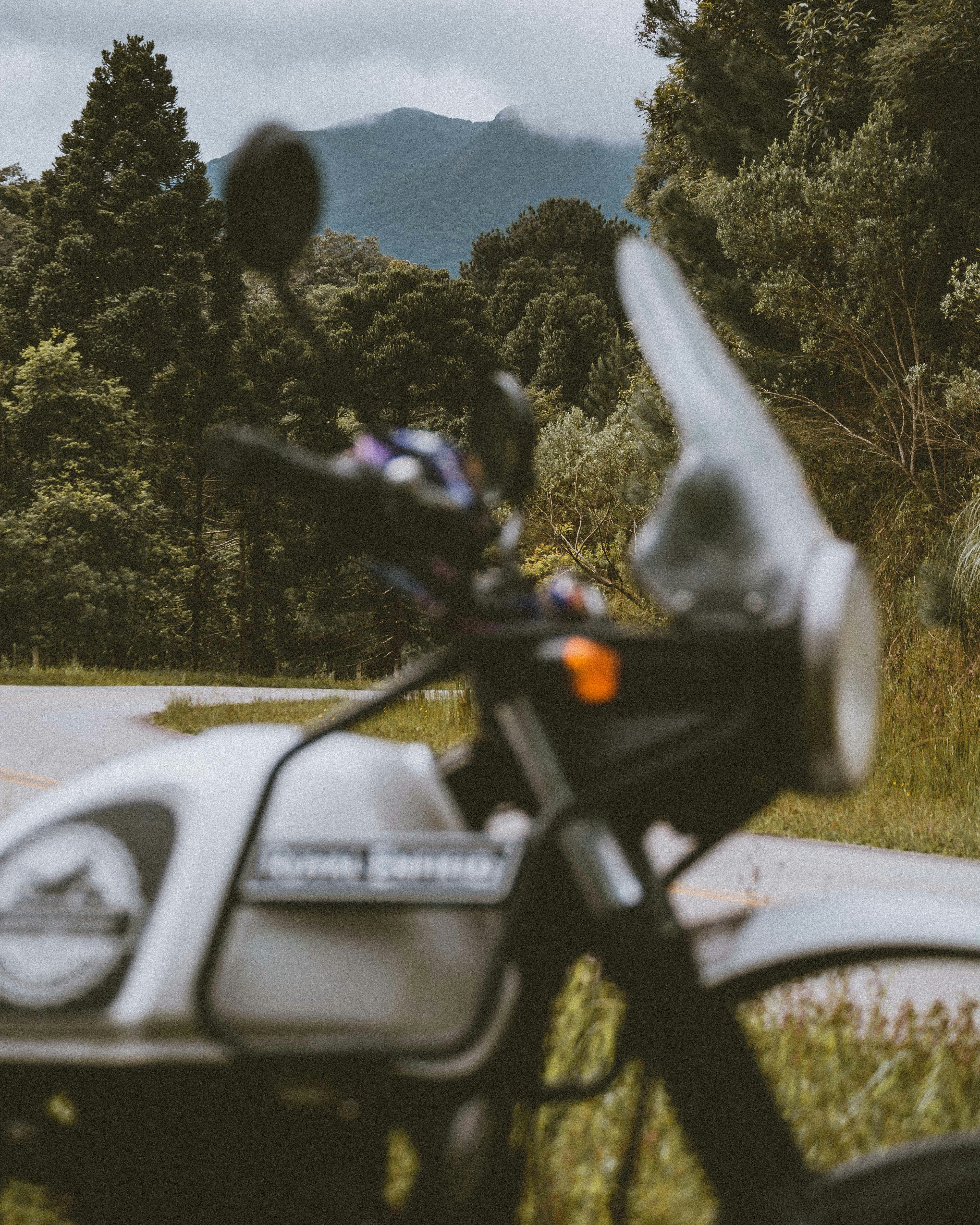 white honda motorcycle parked on gray asphalt road during daytime